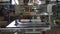 Manipulator with vacuum cups carries metal sheet in workshop