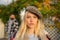 Manly world. Pretty woman in hat. Woman wear checkered clothes nature background. Girl wear kepi. Fall fashion accessory