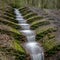 A manmade waterfall in Haigh Woodlands Park, Haigh Plantations, Wigan, Greater Manchester