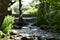 Manmade waterfall on the river under the bridge