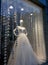 Mannequin behind the glass showcase in a wedding dress