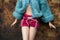 Mannequin doll with a woolen pullover and sexy red short standing in the street