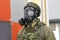 Mannequin head in gas mask and chemical protective suit made of special fabric