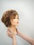 A mannequin head for teaching hairdressing in hands on a light background. Beauty concept.