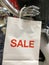 Mannequin holing a sale shopping bag