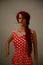 Mannequin with red hair in a red and white polka dot dress