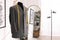 Mannequin with unfinished jacket and measuring tape in tailor shop, space for text