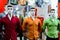 Mannequins dressed in colored shirts in clothing store.