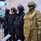 Mannequins in military and police camouflage with helmets, bulletproof vests and protective masks made of bulletproof glasses -