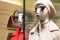 Mannequins in the store with bright lips and long eyelashes demonstrate winter clothing