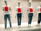 Mannequins wearing white tshirts with red text Sale in window clothing store.