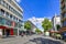 Mannheim, Germany - Shopping street with stores and cable car tracks and with people strolling by on sunny day