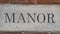 A manor house word photograph on a red brick wall