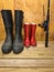 Mans and boys rubber boots with fishing rod