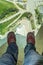 Mans feet on the glass floor of the CN tower