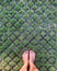 Mans feet over the grass.