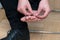 Mans hand applying plaster on terrible blister on human heel