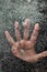 Mans hand below frozen lake drowning