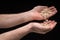 Mans hand pouring spelt flakes from one hand to the other