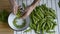 Mans hand shelling fresh ripe green peas bean