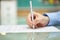 Mans hand is writing document at home on desk