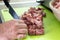 Mans hands cut raw meat with the knife in the kitchen closeup. Preparation of minced meat from fresh pork