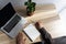 Mans hands, white paper notebook, pencil, laptop and plant on table