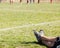 Mans legs relaxing on a grass field