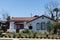 Mansion building on blue sky. Suburb architecture. Suburban housing