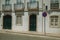 Mansion facade with cracked wall and NO WAITING road sign