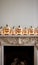 a mantel with pumpkins and candles on it