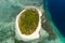 Mantigue Island, Philippines.A small island surrounded by azure water and coral reefs, a top view