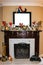 Mantle on vintage marble and wood fireplace decorated for Christmas with fairies and woodland creatures and blank frame for