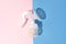 Manual breast pump on blue and pink background with hard shadows