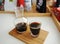 Manual brewing still life. Drip filter black coffee is served in decanter and crystal glass on bamboo board