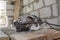 manual circular saw is on a wooden board in house under construction of foam block