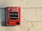 Manual fire alarm On the white stone tile wall