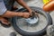 Manual motorbike wheel repair on street