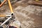 Manual paint removal work: man with gloves using steel wool over a bike frame