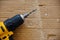 Manual power drill on a background of wooden shavings