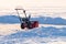 Manual snowplow on a snow field.