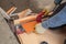 Manual tile cutter. A worker cuts a tile with a tile cutter top view. Laying of ceramic tiles.