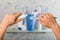 Manual toothbrush and tube of paste in female hands