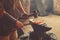 Manual work of a blacksmith in a blacksmith Shop. Hammer blows on the iron billet on the anvil. Forging sword blades is a retro