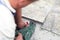 Manual worker disassembling old floor tiles