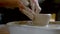 The manufacture of ceramics. Woman prepare clay for work on pottery wheel.