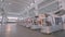 Manufactured woodworking machines stand in a row in stock. A large factory for the production of automated machine tools