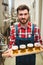 Manufacturer holding beer samples at distillery