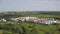 Manufacturing area in field drone view. Aerial top down view of modern technology manufacturing plant. Aerial top view