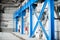 Manufacturing factory. Empty hangar building. Blue toned background. The production room with large windows and metal structures